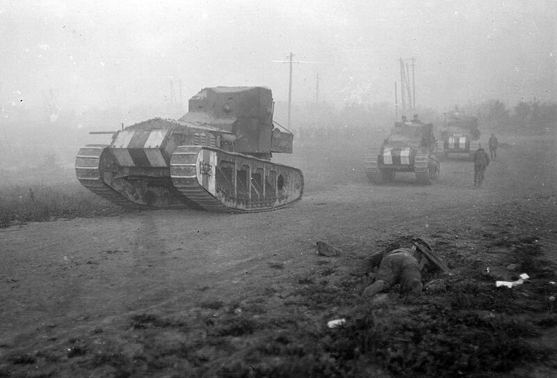 British Medium Mark A Whippet tanks advance past the body of a dead soldier, moving to an attack along a road near Achiet-le-Petit, France, on August 22, 1918. The Whippets were faster and lighter than previously deployed British heavy tanks.