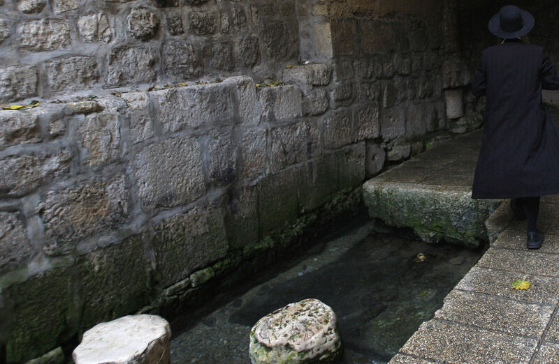 An Ultra-Orthodox Jewish man enters the Siloam pool in the East Jerusalem neighbourhood of Silwan October 23, 2009. The pool standing today dates the Byzantine Era and is located at the site where Christians believe that Jesus instructed a blind man wash, granting him sight. (photo credit: REUTERS/GIL COHEN MAGEN)