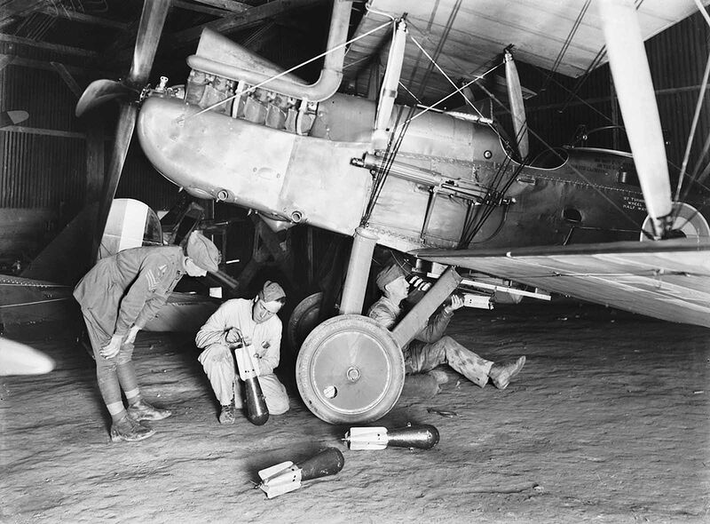 An unidentified member of the 69th Australian Squadron, later designated No. 3 Australian Flying Corps, fixes incendiary bombs to an R.E.8 aircraft at the AFC airfield north west of Arras. The entire squadron was operating from Savy (near Arras) on October 22, 1917, having arrived there on September 9, after crossing the channel from the UK.
