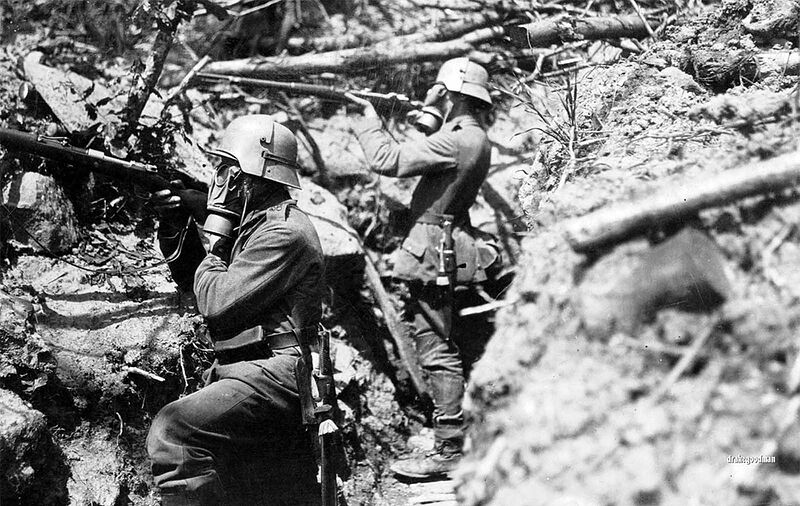 German infantrymen from Infanterie-Regiment Vogel von Falkenstein Nr.56 adopt a fighting pose in a communication trench somewhere on the the Western Front. Both soldiers are wearing gas masks and Stahlhelm helmets, with brow plate attachments called stirnpanzers. The stirnpanzer was a heavy steel plate used for additional protection for snipers and raiding parties in the trenches, where popping your head above ground for a look could be lethal move.