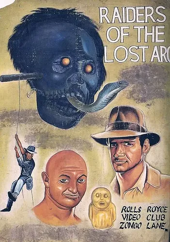 Illustrated movie poster with a skull, snake, adventurer, and golden idol. Text: "Raiders of the Lost Arc" and "Rolls Royce Video Club Zongo Lane."