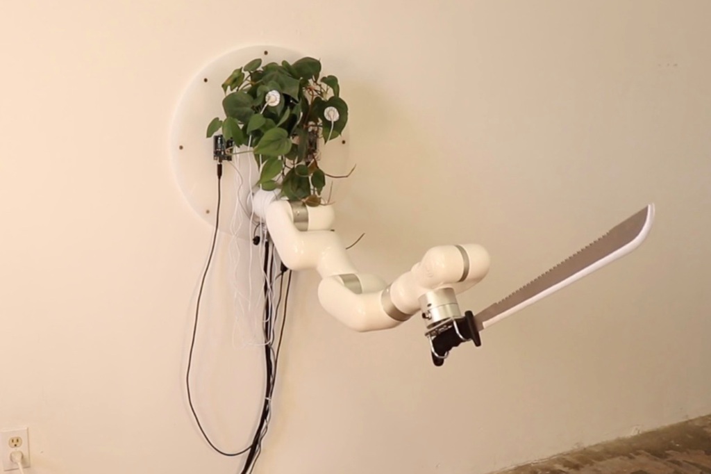This literal grasscutter uses "an open source micro-controller connected to the plant to read varying resistance signals across the plant’s leaves."