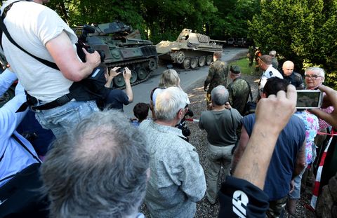 residents watch the transportation of a world war two era panther battle tank from a residential property in heikendorf, germany, 02 july 2015 since 01 july, police and armed forces are removing recently discovered military equipment from world war ii including the panther tank, weapons and a torpedo the armoured recovery vehicle is used for safe transportation of weapons photo carsten rehderdpa usage worldwide photo by carsten rehderpicture alliance via getty images