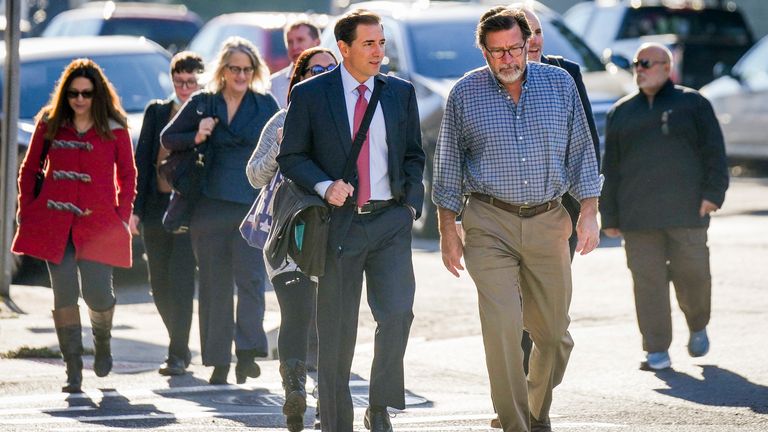 Bill Sherlach, front right, whose wife Mary was killed, and other plaintiffs and their lawyers arriving at court on Wednesday