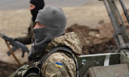 Ukrainian government soldiers dig trenches east of the port city of Mariupol.