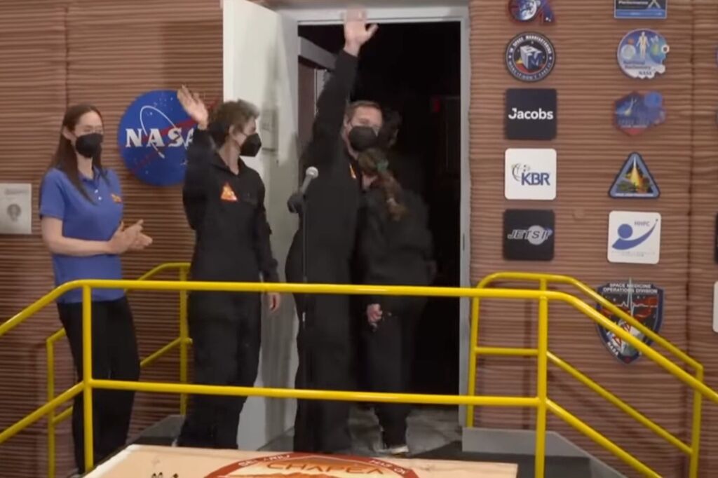 The crew members wave goodbye to the crowd moments before being locked in the habitat until July 2024.