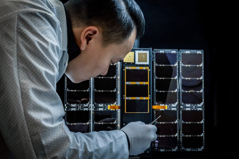 Technician works on Moonlighter experimental satellite